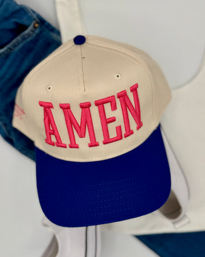 Beige and blue cap with 'AMEN' in pink on a white background