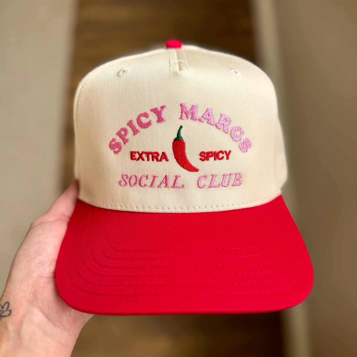 Cap with 'Spicy Margs Extra Spicy Social Club' text and red chili pepper on beige and red cap.