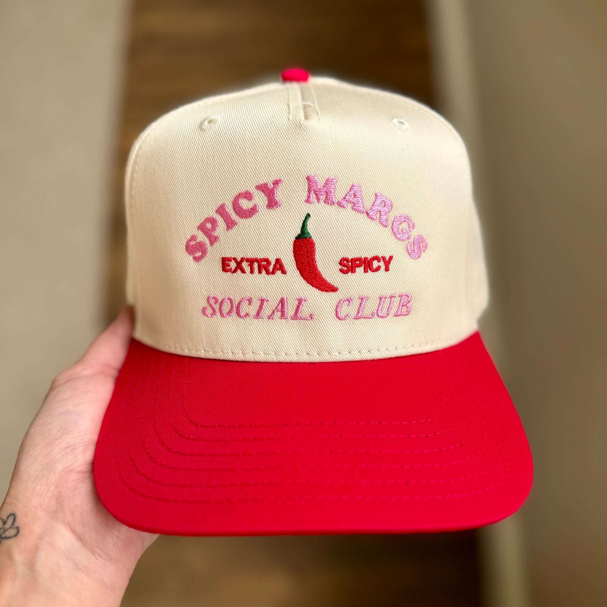 Cap with 'Spicy Margs Extra Spicy Social Club' text and red chili pepper on beige and red cap.
