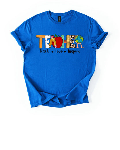 Blue t-shirt with colorful 'TEACH LOVE INSPIRE' design on a white background