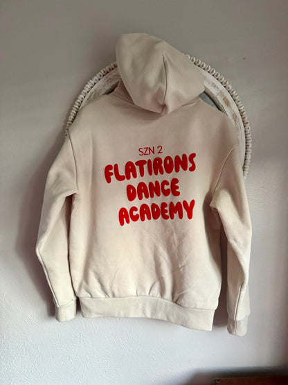 Beige hoodie with red text 'SZN 2 FLATIRONS DANCE ACADEMY' on a white background