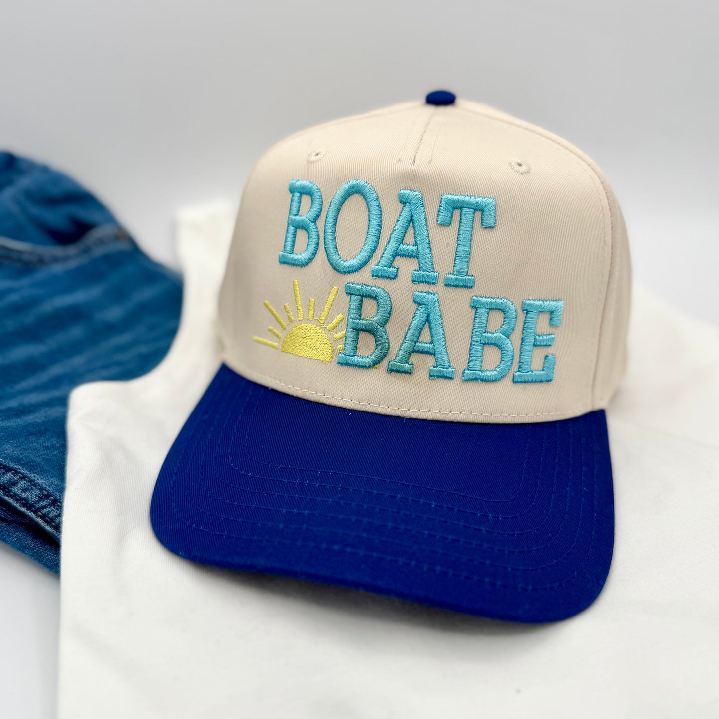 Cap with 'BOAT BABE' text on a white background