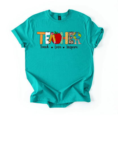 Teal t-shirt with colorful graphic and text 'TEACH LOVE INSPIRE' on a white background