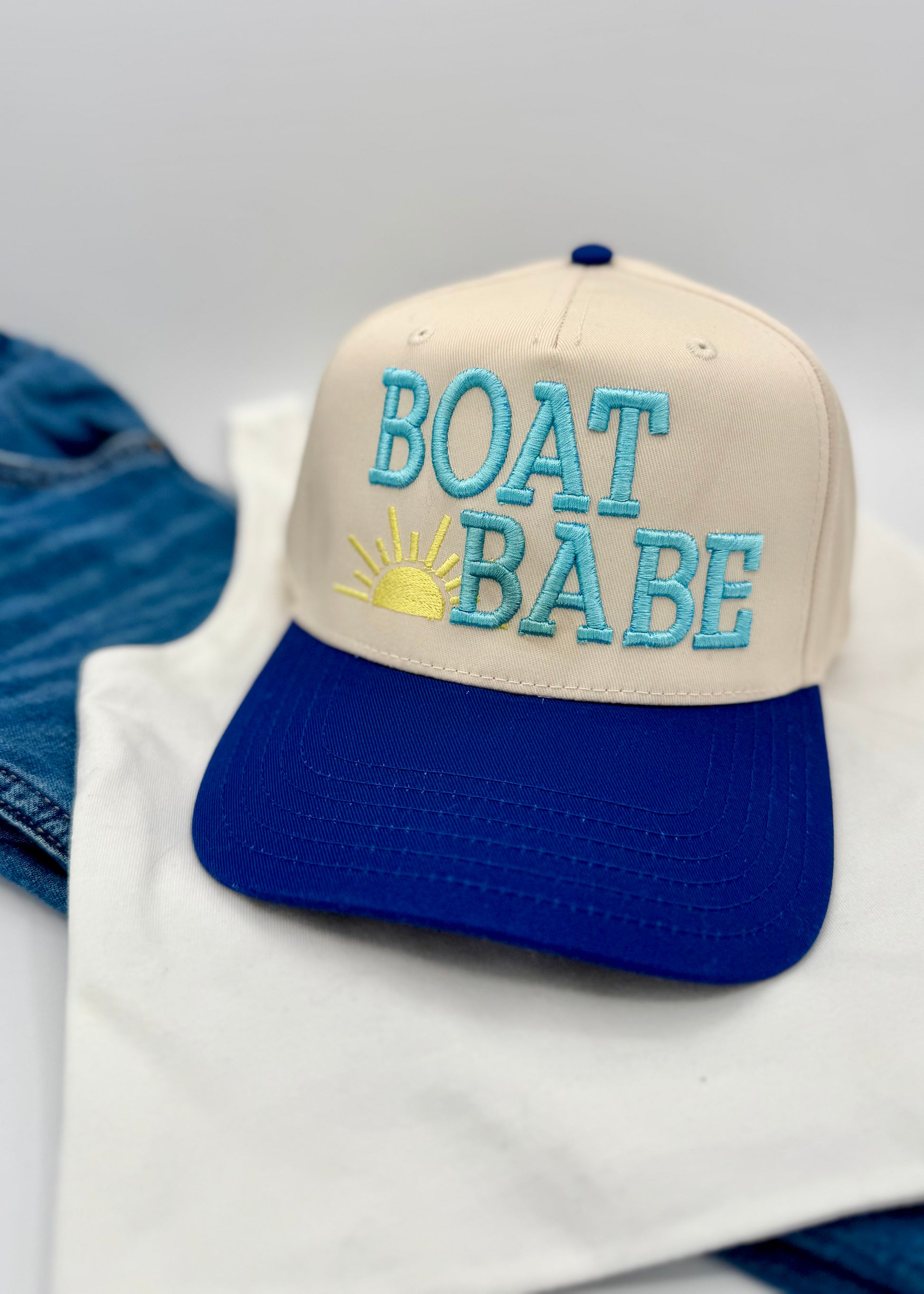 Cap with 'BOAT BABE' text on a white surface