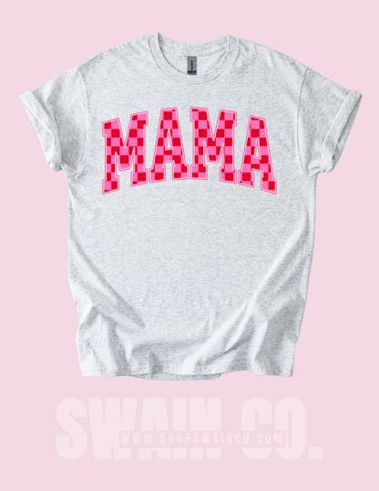 White t-shirt with pink 'MAMA' text on a pink background