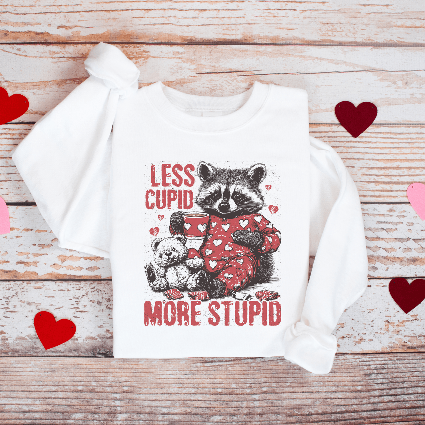 Less Cupid, More Stupid Anti-Valentine’s Day Raccoon Sweatshirt - Swain Co. Designs & Apparel