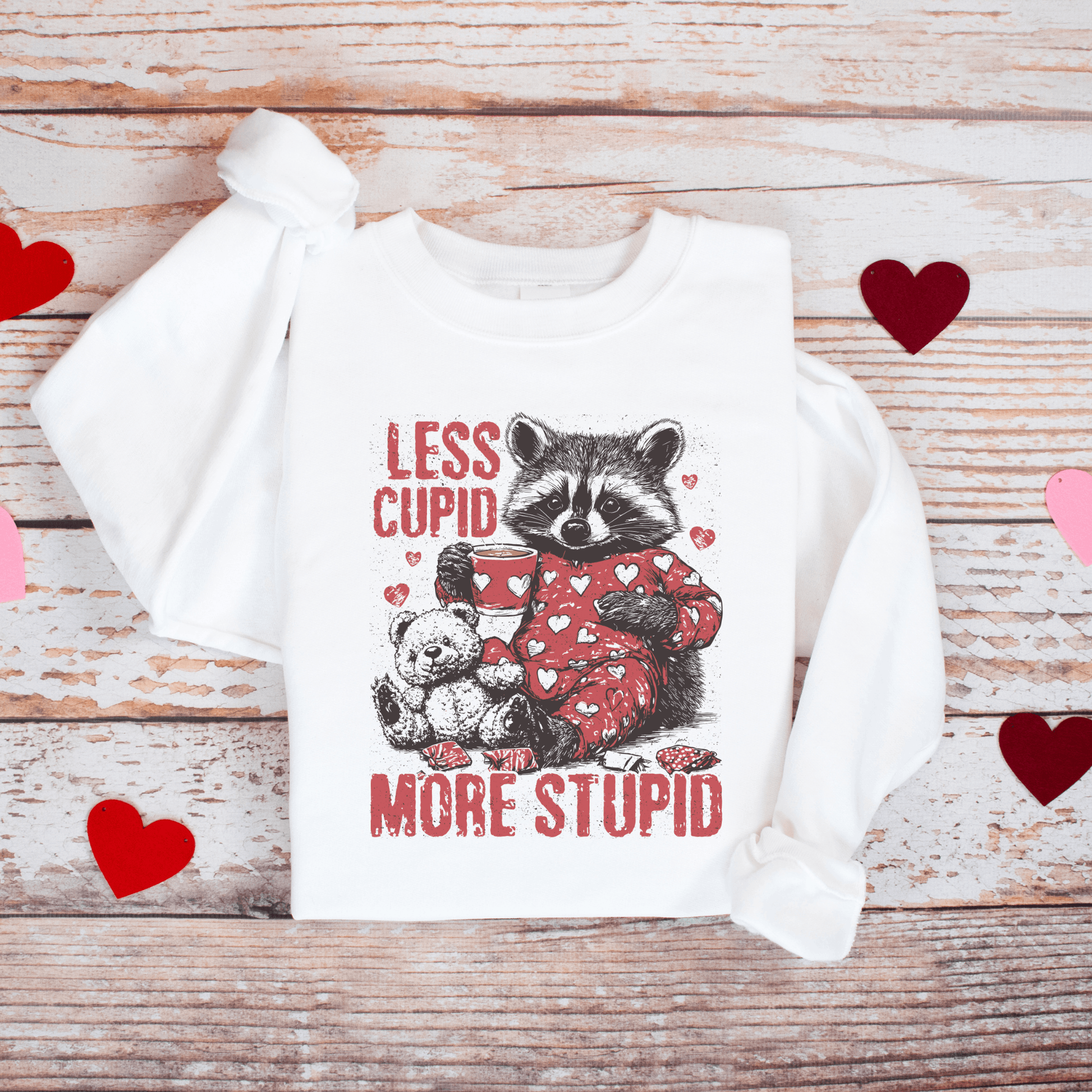 Less Cupid, More Stupid Anti-Valentine’s Day Raccoon Sweatshirt - Swain Co. Designs & Apparel