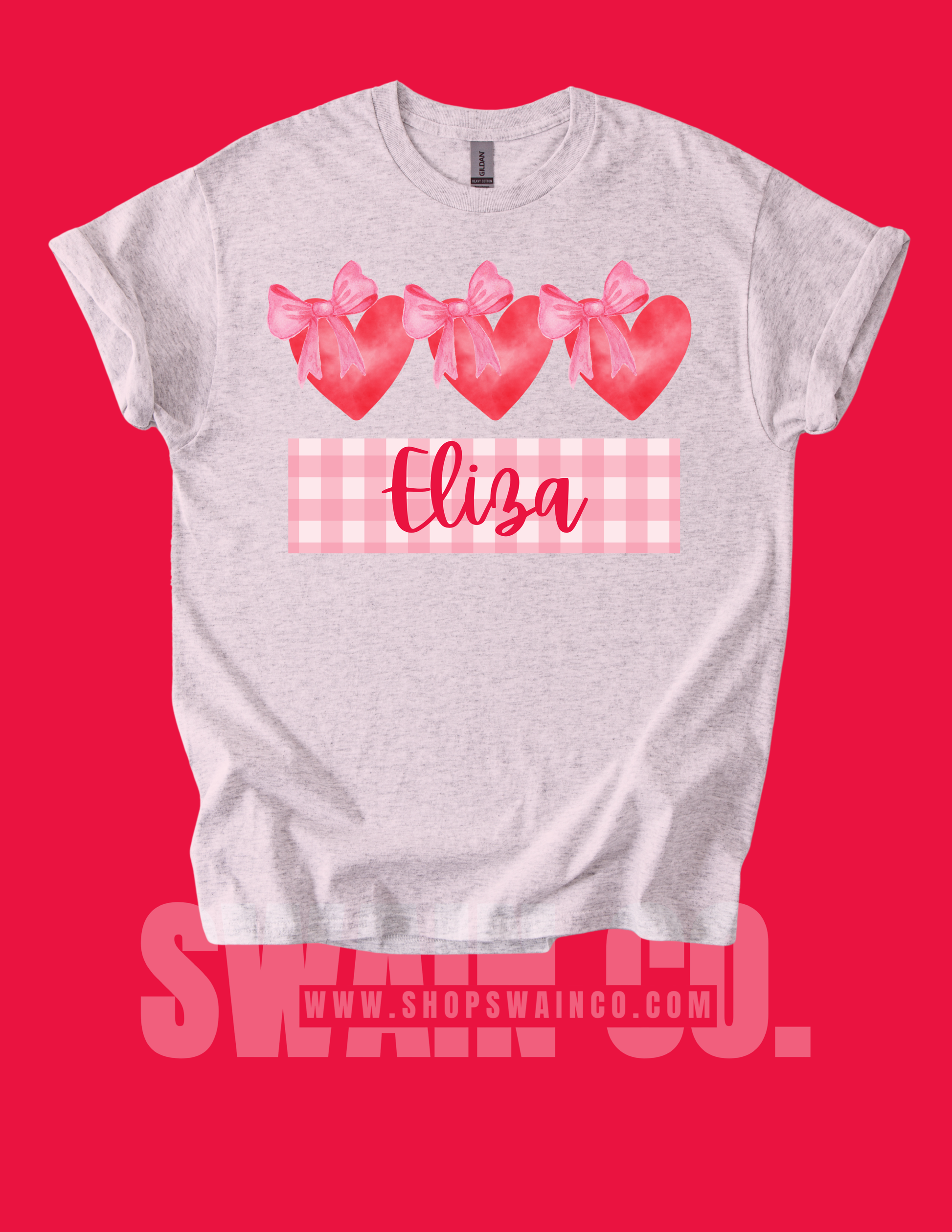 Gray t-shirt with pink hearts and bows on a red background