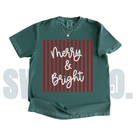 Green t-shirt with 'Merry & Bright' text on a red striped background
