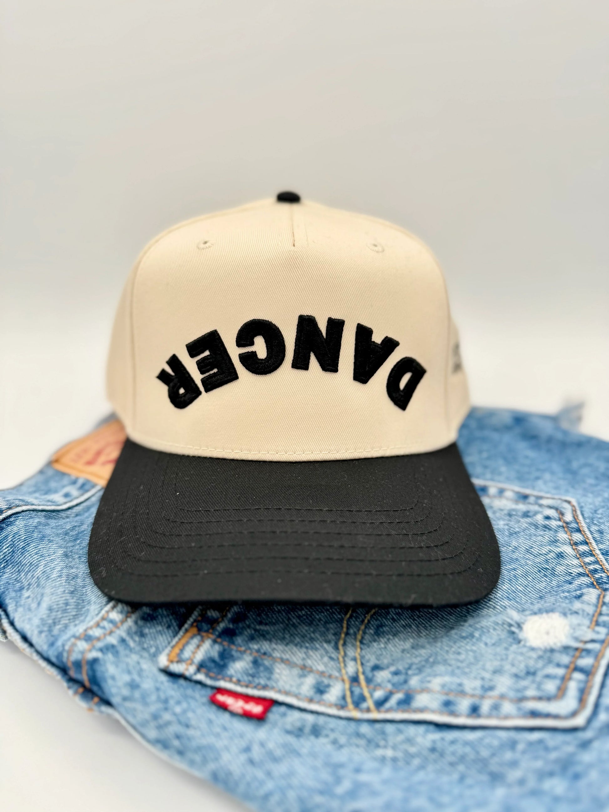 Beige and black cap with 'DANCER' 