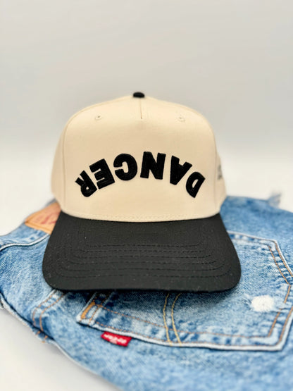 Beige and black cap with 'DANCER' 