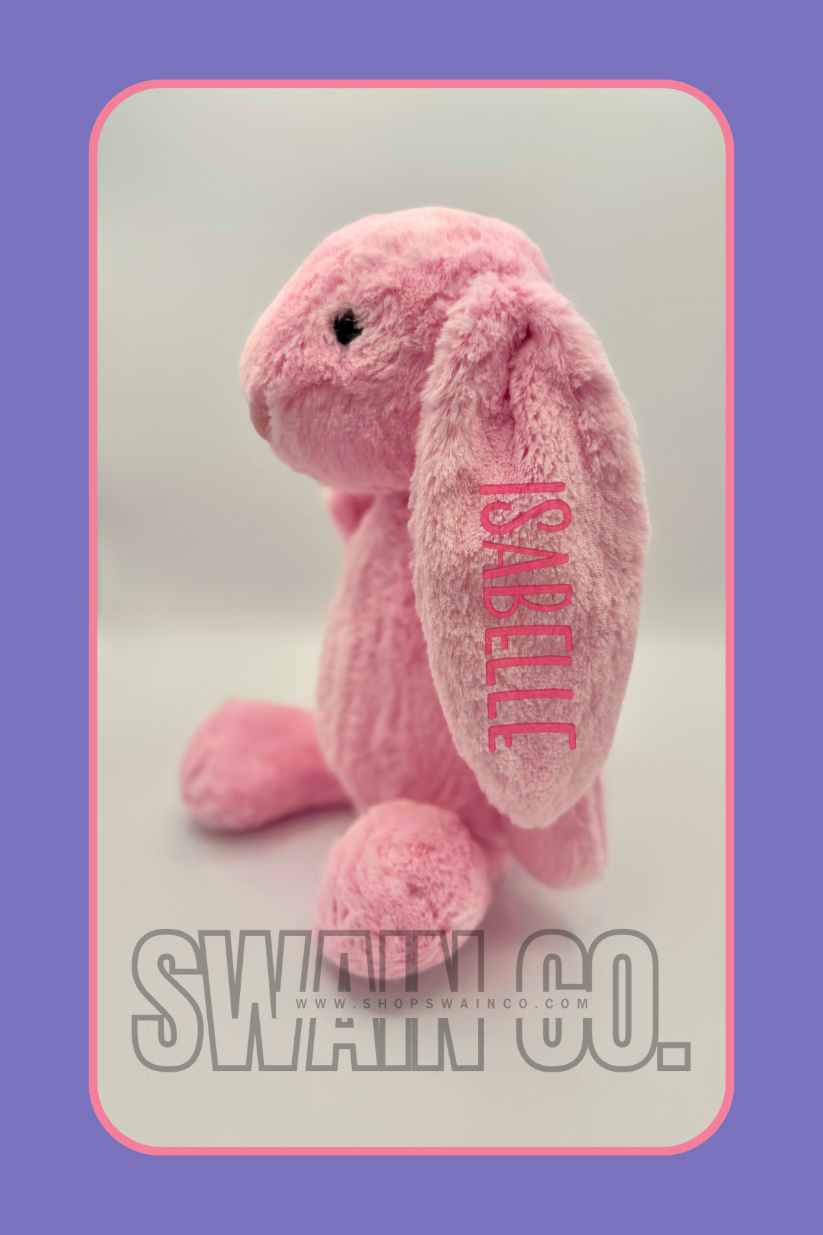 Pink plush toy with 'Korali' branding on a light gray background