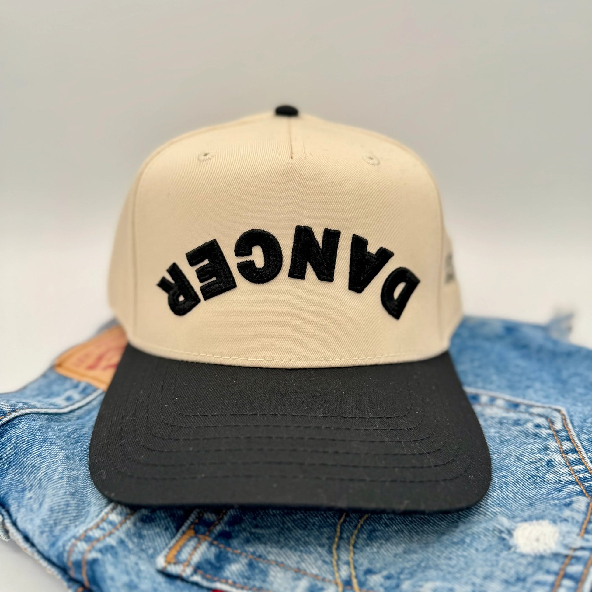 Beige cap with black 'DANCER' text with black bill