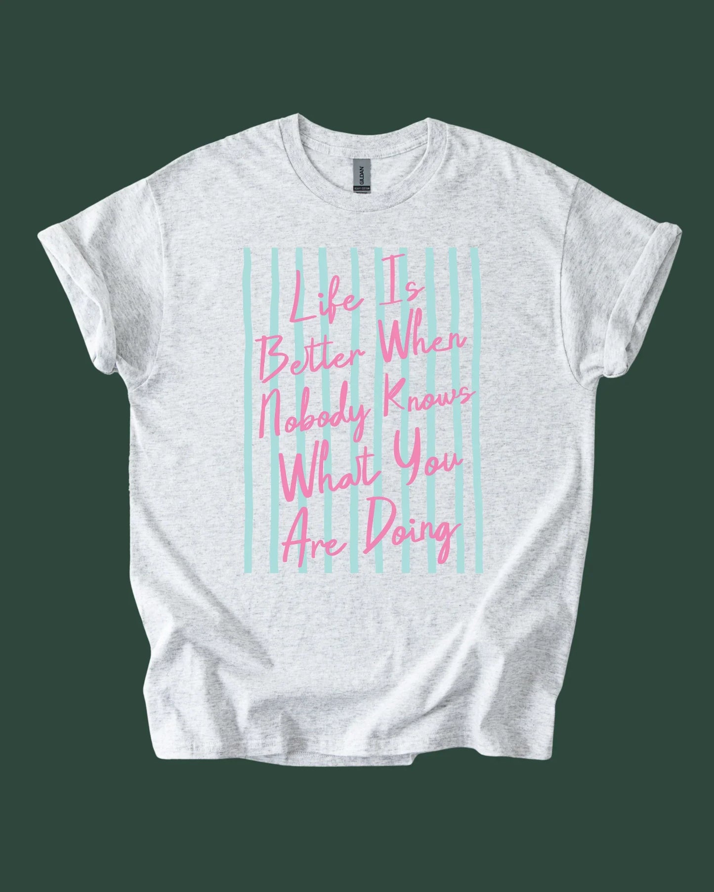 White t-shirt with pink text on a green background