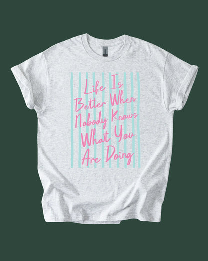 White t-shirt with pink text on a green background
