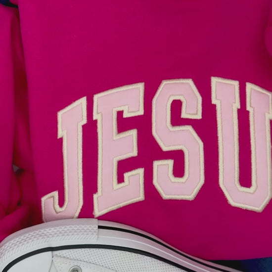 video of pink jesus applique crewneck
