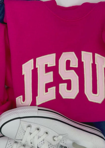 video of pink jesus applique crewneck