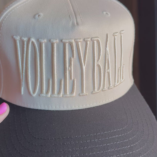 Video showing monochromatic hat with VOLLEYBALL across the front.
